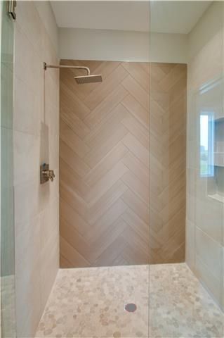 Shower Chevron Tile, Herringbone Wood Tile Bathroom, Master Shower Wood Tile, Wood Tiled Bathrooms, Wood Slat Look Tile, Modern Wood Tile Shower Ideas, Marble And Wood Look Tile Bathroom, Chevron Tile Bathroom Shower Walls, Wood Like Tile Shower Walls