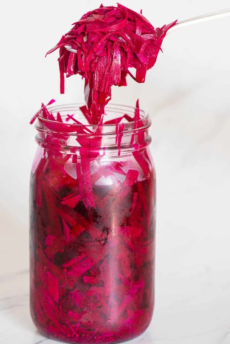 Vibrant homemade raw pickled beets are tangy, delicious, so good for you, easy to make, and ready to enjoy after a day in the refrigerator! Thinly sliced beets are covered in a hot brine of vinegars, water, salt, pickling spice, and a bit of sugar. Enjoy them on salads, sandwiches, or on their own when you're craving superfood with a kick. When they're gone, use the brine to make gorgeous pink pickled eggs. Grated Pickled Beets, Pickled Shredded Beets, Pickled Items, Quick Pickle Recipe, Pickle Seasoning, Pickled Beets Recipe, Pickled Turnips, Pickled Red Cabbage, Beetroot Recipes