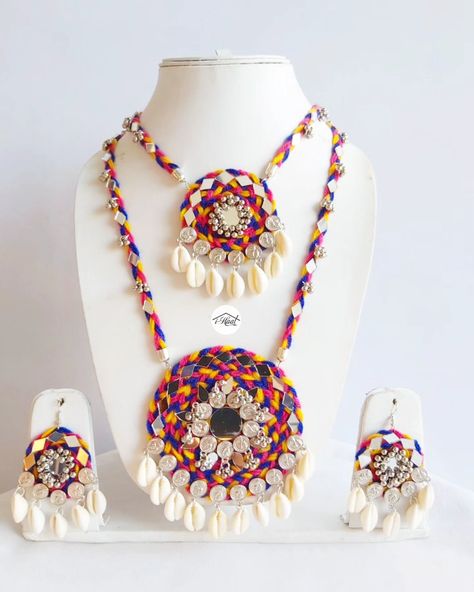 Are you someone who's already been shopping for her Navratri look? Checkout this beautiful Multicolored jewellery set adorned with lots of mirrors, Cowrie shells, coins and ghungroo to match your Garba Vibes for this Navratri Season 🔥 This 2 layered long necklace and earrings makes you stand out in the crowd and match perfectly with every outfit ❤️ Visit indiashaat.com for more handmade jewellery options #indiashaat #navratrijewellery #bohojewellery #multicolorjewellery #letajaijo [Ha... Handmade Navratri Jewellery, Navratri Jwellery Ideas, Necklace For Navratri, Kori Jewellery, Navratri Accessories, Navratri Necklace, Garba Jewellery, Navratri Ideas, Navratri Look