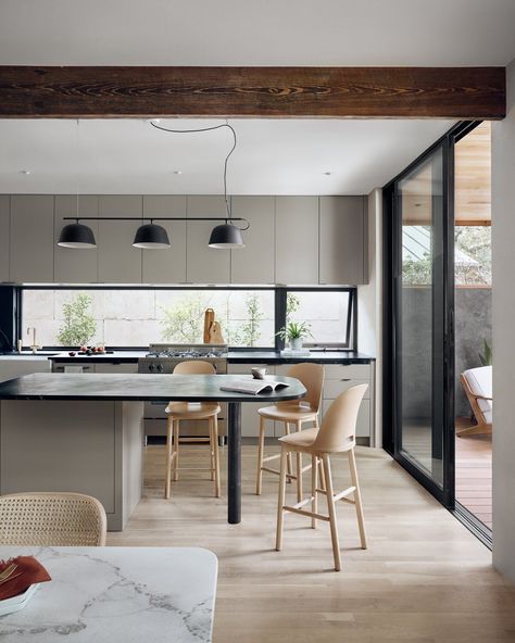 A long window was used as a backsplash in the kitchen to bring in even more light to the space. #dwell #modernarchitecture #austin #homerenovation #moderndesign Contemporary Stools, Hm Home, Light Hardwood, Light Hardwood Floors, Versatile Furniture, Durable Furniture, House Siding, Sustainable Furniture, Kitchen Photos