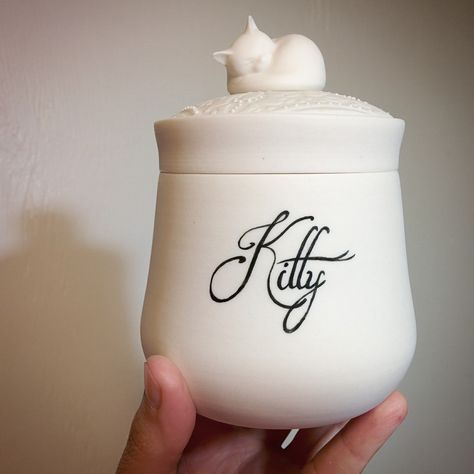 Just finished a few custom porcelain pet urns with handpainted names. No standard brass nameplates here; just a tiny paintbrush, black pigment, and a steady hand! Pet Cremation Urns, Cat Urns, Pet Urn, Cat Sculpture, Cat White, Pet Cremation, Pet Ashes, Black Pigment, Pet Urns