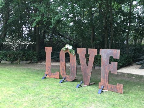 Our custom-made giant LOVE sign in rustic finish, with fresh floral garland. Solar spotlights turn this into a dramatic feature as dusk arrives. Wedding Big Letters, Giant Letters Wedding, Large Light Up Letters Wedding, Giant Light Up Letters Weddings, Large Wooden Letters Wedding, Floral Arrangements Wedding, Floral Garland, Love Signs, Floral Centerpieces