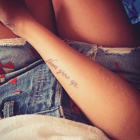 42 Beautifully Simple Wrist Tattoo Ideas You'll Love Never Grow Up Aesthetic, Never Grow Up Tattoo, Believe Wrist Tattoo, Love Wrist Tattoo, Wrist Tattoos Words, Lovely Tattoo, Meaningful Word Tattoos, Faith Tattoo On Wrist, Simple Wrist Tattoos