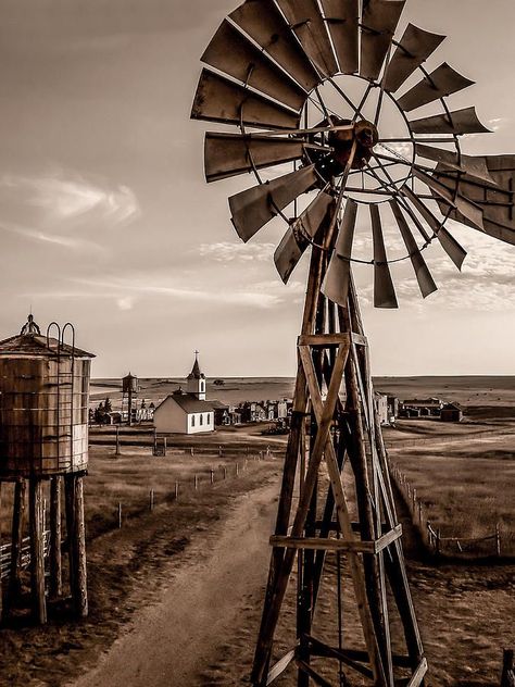 An old windmill standing as a sentinel over the old town on the western frontier. Description from finearta… | Western photography, Old western towns, Western photo Western Aesthetic Wallpaper, Old Western Towns, Old West Town, Country Backgrounds, Western Photo, Old Windmills, Western Artwork, Western Photography, Cowboy Aesthetic