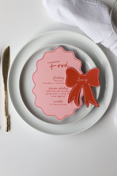 Blush pink menu & bow place card templates | pink and red hens bachelorette party, wavy border menu, hand drawn bow place cards, handwritten menu wavy border dinner menu, pink and red bow shaped place cards  Elevate Your Event with Effortless Elegance  Our editable templates are not just an invite, a menu or a sign; they are a statement piece that sets the tone for an unforgettable soirée. Designed with impeccable aesthetics and convenience in mind, our templates are a must-have for every modern Card Shapes Ideas, Cricut Menu Cards, Birthday Place Cards, Pink Invite, Menu Aesthetic Design, Birthday Menu Ideas, Place Setting Ideas, Menu Aesthetic, Bow Dinner Party