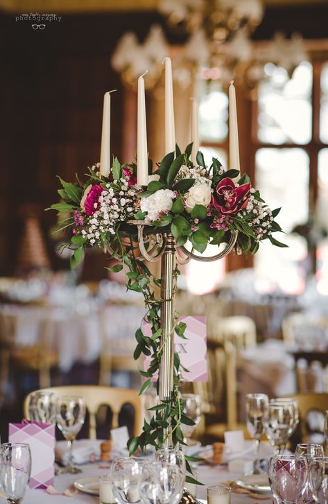 A stunning floral candelabra centrepiece Candelabra Floral Arrangements, Candelabra Table Setting, Flower Candelabra Centerpiece, Candelabra Wedding Centerpieces Flowers, Wedding Candelabra Centerpiece, Candleabras Centerpiece, Diy Candelabra Centerpiece, Candelabra With Flowers, Cheap Wedding Table Centerpieces