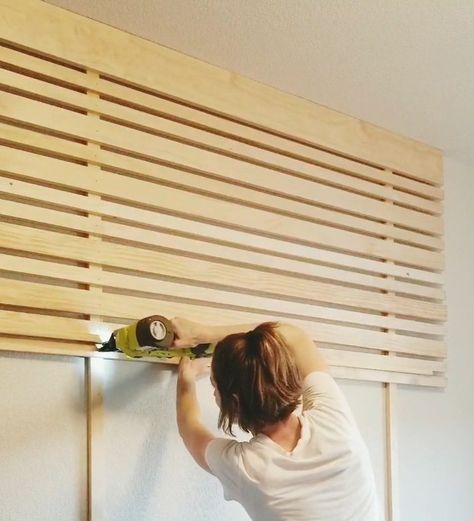 This slat accent wall   headboard is super affordable and an easy DIY project done in just a few hours.  Instructions:  Find the studs you’re going to attach the eight-foot vertical boards to. The studs were four feet apart which means there will be a foot of the horizontal board hangover on each side. Our bedroom ceilings are nine feet tall so I had to cut two, one-foot pieces from the third board. Use wood screws to attach the vertical boards that go from floor to ceiling.  Start at… Accent Wall Headboard Wood, Horizontal Slatted Wall, Dowel Accent Wall, How To Make A Slat Wall, Bed Accent Wall Ideas, Vertical Boards On Wall, Horizontal Wood Wall Interior, Decorative Slat Wall, Easy Slat Wall