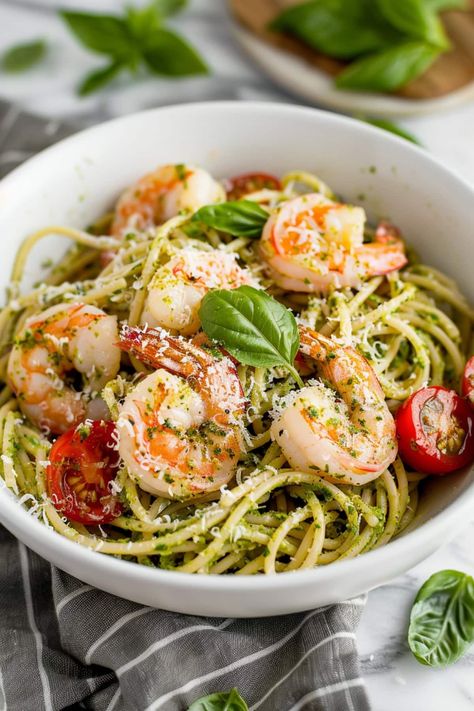 This pesto shrimp pasta features succulent shrimp, salty Parmesan, and bright cherry tomatoes in a garlicky pesto sauce with plenty of tender noodles. Pesto Shrimp Pasta, Shrimp Pesto Pasta, Pesto Shrimp, Pesto Pasta Recipes, Yummy Dishes, Dinner Club, Tomato Pesto, Pasta Dinners, Pasta Sauces