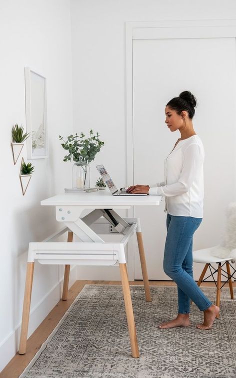 Inscape, a local office furniture supplier with a sleek showroom at Bay and Wellington, recently updated one of their popular office desks for the home. The Scandinavian-inspired design—available in a white or walnut surface with pale wood or metal legs—is unassuming when it’s lowered but lifts easily up and slightly forward to ergonomically complement a good standing position. Small Adjustable Standing Desk, Mcm Adjustable Desk, Home Office 2 Monitors Computer Desks, Sitting And Standing Desk, Sit To Stand Desk Home Office, Stand Up Desk Decor, Home Office Eames Chair, Home Office For Small Spaces Bedroom, Sit And Stand Desk Home Office