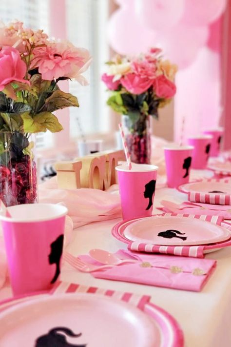 The pink Barbie silhouette papers plates and cups are totally on-theme and will elevate your Barbie birthday party to another level. The gorgeous floral arrangements are the perfect party decoration and will make your table settings so pretty. See more party ideas and share yours at CatchMyParty.com Centerpieces For Barbie Party, Barbie Theme Table Set Up, Barbie And Ken Birthday Party Theme, Barbie 21 Birthday Party, Barbie Party Table Setting, Barbie Themed Table Decor, Barbie Birthday Favor Ideas, Barbie Centre Pieces, Barbie Party Treat Table