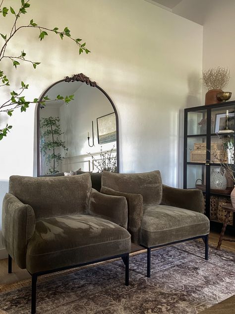 Velvet Chair And Ottoman, Comfortable Sitting Room Ideas, Green Sofa With Accent Chairs, Penn Chair West Elm Living Room, West Elm Penn Chair Olive, Olive Green And Cognac Living Room, Two Arm Chairs In Living Room, West Elm Penn Chair Styled, Chair Beside Fireplace