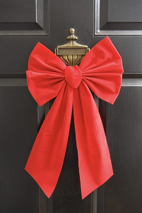 A big bow makes your door festive and welcoming. How To Make Christmas Tree Ribbon, Front Door Christmas Bows, Door Bows Christmas, Christmas Door Bow, Door Bow, 달력 디자인, Outside Christmas Decorations, Big Doors, How To Make Christmas Tree