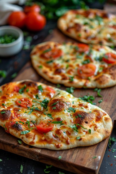 Three freshly baked naan flatbreads topped with melted cheese, cherry tomatoes, and fresh herbs on a wooden board. Naan Mini Pizza, Pizza Using Naan Bread, Air Fryer Bagel Pizza, Naan Pizza Oven, Stonefire Naan Recipes, Naan Bread Pizza Air Fryer, Pita Pizza Air Fryer, Nan Bread Meal Ideas, Nan Bread Ideas