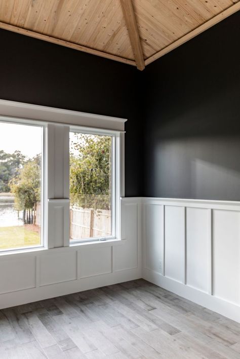 Vaulted wood ceiling with black painted walls and a white trim chair rail White Beadboard Black Walls, Walls With Middle Trim, Black Walls With Chair Rail, Black Chair Rail Wainscoting, Dark Paint White Wainscoting, Two Toned Chair Rail, Modern Chair Rail Bedroom, White Chair Rail Dining Room, Tall Chair Rail Ideas