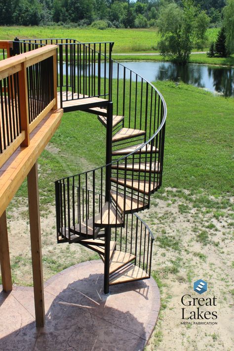 Tall circular metal stairs or wrought iron spiral staircase connect this cedar deck to the patio below Outdoor Spaces, Stairs Exterior, Raised Patio, Deck Builders, Custom Decks, Spiral Stairs, Spiral Staircase, Outdoor Projects, Patio Deck