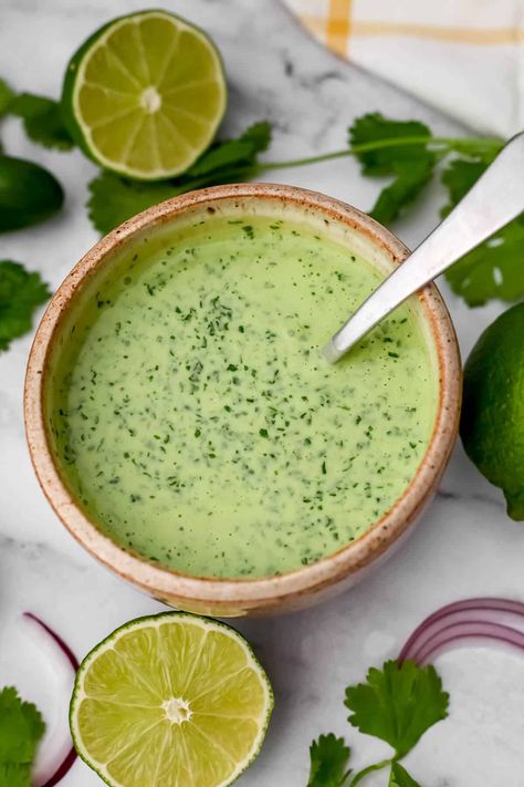 This spicy vegan cilantro lime crema will take all your Mexican-style foods to the next level! This creamy cilantro lime sauce is perfect for drizzling on tacos, nachos, burritos, and soups. Cilantro Lime Crema Recipe, Cuban Mojo Chicken, Lime Crema Recipe, Spicy Crema, Healthy Sauce Recipes, Cilantro Lime Crema, Mojo Chicken, Cuban Mojo, Vegan Sauce Recipes