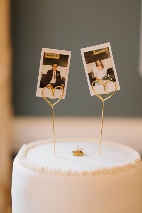 we took polaroids of each other before our wedding meal and used them as our cake topper along with a gold ring with a dove that my grandparents used on their wedding cake 63 years prior. Wedding Cake Toppers Polaroid, Minimalist Cake Topper Wedding, Cake Topper Polaroid, Polaroid On Wedding Cake, Cake With Polaroid Pictures, Alternative Wedding Cake Toppers, Diy Wedding Topper, Wedding Cake With Polaroid, Cake With Photo Topper