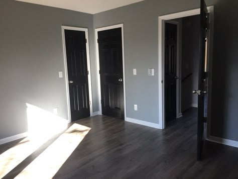 Black interior doors Black Farmhouse Door Interior, Grey Walls And Black Trim, House Black Doors Interior, Black Walls Grey Floor, Gray Walls And Black Doors, Black Interior Doors Grey Walls, Black Interior Doors With Gray Walls, Black Panel Doors Interior, Black Doors Interior Grey Walls