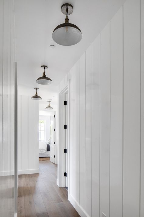 Tongue and groove paneling and barnhouse lighting Painted Vertical Shiplap Walls, White Vertical Shiplap, Wide Vertical Shiplap, Vertical Paneling, Vertical Shiplap, Shiplap Hallway, Shiplap Paneling, White Wall Paneling, Tongue And Groove Walls