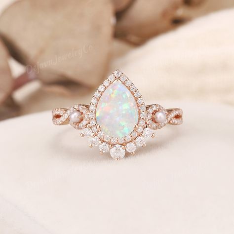 Vintage White Opal Engagement Ring Pearl Engagement Band Rose Gold Vine Ring Infinity Ring Flower Stacking Ring Unique Pear opal Ring Halo ✦ Handmade, high-quality item ✦ Material: SOLID 10K/14K/18K GOLD ( can be made in yellow/white/rose gold ) ✦Engagement ring ✦ Center stone: Lab opal  ✦ Size/Weight: 6*8mm ✦ Cut: Pear Shaped ✦ Side stones: Moissanite, or Natural Diamonds; and natural small pearls ✦ Weight: About 0.386ct  ✦ Color: DEF Color ✦ Cut: Round Shaped ✦ Band Width: Around 1.6mm PRODUCT Gold Opal Ring Engagement, Opal Pearl Ring, Opal And Diamond Engagement Rings, Pear Opal Ring, Engagement Ring Pearl, Opal Engagement Ring Vintage, Fairytale Engagement Rings, White Opal Engagement Ring, Trendy Silver Jewelry