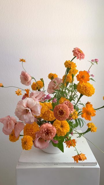 Marigold And Zinnia, 60s Flower Arrangements, Yasmine Mei Floral Design, Orange Flower Decorations, Marigold Wedding Centerpieces, Cosmos And Marigold Bouquet, Orange Marigold Bouquet, Pink Yellow Orange Flower Arrangement, Cempasuchil Flower Arrangement