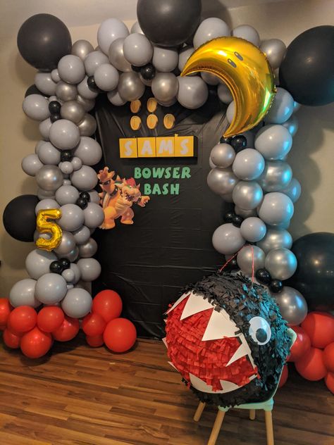 Super Mario bowser party balloon garland backdrop with chain chomp piñata 5th birthday party ideas Mario Backdrop Ideas, Bowser Birthday Party Decorations, Mario Birthday Party Bowser, Bowser Theme Party, Bowser Jr Birthday Party, Bowser Party Decorations, Bowser Birthday Party Ideas, Bowser Party Ideas, Mario Birthday Decor