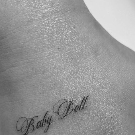 Mikella Blue on Instagram: "baby doll ♡  -  For booking click link in bio  -  #tattoo #losangeles #MikellaBlue #tattooartist #ladytattooer #fineline #blackandgrey #script #babydoll" Doll Tattoo Word, Babydoll Tattoo Lettering, Baby Doll Tattoo, Babydoll Tattoo, 24 Tattoo, Baby Tattoo, French Tattoo, Script Tattoo, Small Tats