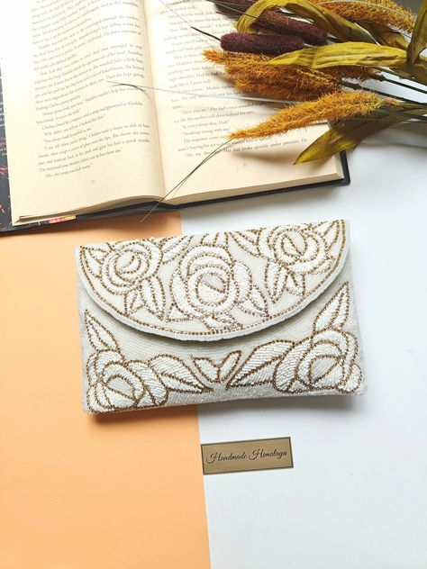 Handcrafted golden-white floral beaded envelope clutch purse featuring intricate beadwork, ideal for bridal occasions, elegant crossbody shoulder bag option, perfect wedding day accessory, unique handmade gift for her Beaded Clutch Purse, Formal Parties, Floral Clutches, Bridal Bag, White Purse, Embroidery Bags, Bridal Clutch, Beaded Bag, Evening Handbag