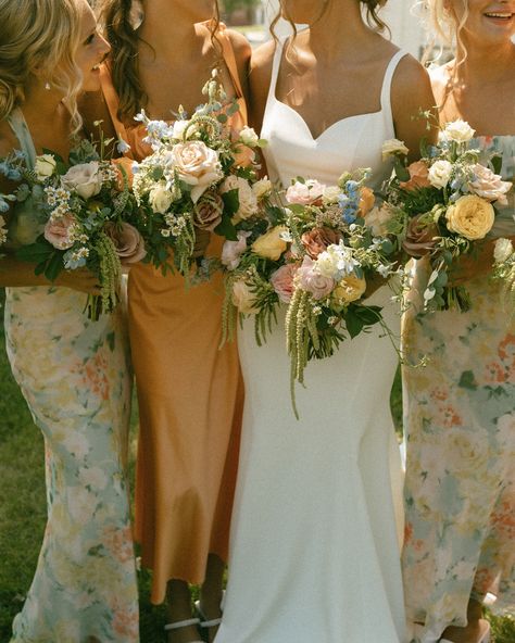 I hope colorful wedding days are here to stay 😌 especially the whimsy florals & mix and match bridesmaid dresses 🧡 #iowaweddingphotographer #desmoinesweddingphotographer #desmoineswedding #weddingcolorscheme #colorfulwedding #iowaphotographer Floral Mix Match Bridesmaid Dresses, Peach And Sage Bridesmaid Dresses, Mix Match Floral Bridesmaid Dresses, Spring Floral Bridesmaid Dresses, Mix Match Bridesmaid Dresses Spring, Mix Match Bridesmaid Dresses Fall, Fall Floral Bridesmaid Dresses, Boho Bridesmaid Dress Mismatched, Wild Flower Bridesmaid Dresses