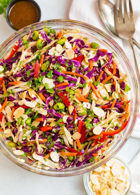 This crunchy Asian Cabbage Salad is colorful, healthy, and absolutely delicious! Made with raw cabbage, carrots, edamame, and almonds, it's topped with an addictive ginger peanut dressing. The perfect healthy side dish for potlucks or leftover for quick and easy lunches. Ginger Peanut Dressing, Salad With Edamame, Asian Cabbage Salad, Asian Cabbage, Raw Cabbage, Potluck Side Dishes, Peanut Dressing, Cabbage Salad, Healthy Side