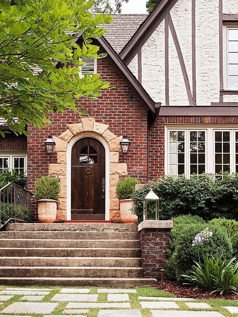 A stone-framed entry provides pleasing contrast to this home's brick exterior: http://www.bhg.com/home-improvement/door/exterior/exterior-doors-and-landscaping/?socsrc=bhgpin060314stoneaccent&page=2 Brick Siding, Elegant Doors, Tudor Style Homes, Casa Exterior, Tudor House, Exterior Cladding, Tudor Style, Front Entrances, Timber Framing