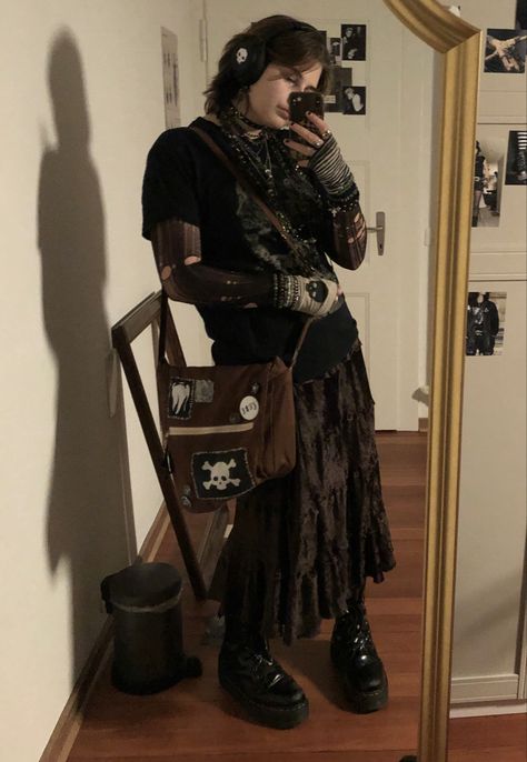 A mid-sized person/girl wearing a    black grephic t-shirt, black tights top, graphic mismatched fingerless gloves, dark brown maxi skirt, platform dr. Martens and multiple dark green and gray crystal rings and bracelets. 		The person is also wearing multiple silver necklaces. Plaguecore Fashion, Eco Goth Fashion, Alt Winter Outfits Masc, Masc Tradgoth Outfits, Plus Size Alt Fashion Masc, Crowcore Outfit Men, Maximalism Aesthetic Outfit, Whimsigoth Fashion Masc, Alt Fashion Masc