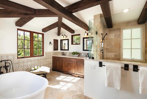 Spanish Mediterranean master bathroom interior design in Santa Barbara. Wood beams, hand painted wall tile wainscotting, limestone shower and floors, soaking tug | Santa Barbara Mediterranean Bathroom Ceiling Ideas, Wooden Ceiling Beams, Spanish Mediterranean Homes, Mediterranean Bathroom, Timeless Home Decor, Santa Barbara Style, Stone Vanity, Spanish Mediterranean, Mediterranean Interior