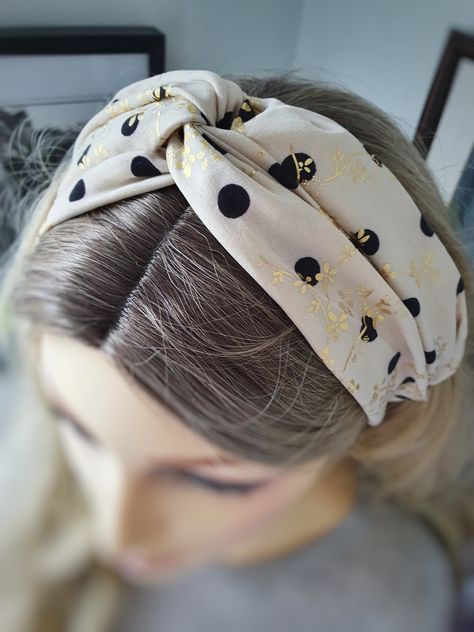 "A retro style hairband handmade in the UK from silky soft fabric. This elasticated headband is a lovely accessory for everyday or special occasions. Women's one size twisted knot silky sand and black flower hairband with elasticated back. This gorgeous silk headband is perfect for both summer and winter months, with a lovely retro flower design on a beige silky background. This feminine hair accessory is easy to wear and comes in one size, which fits all. A lovely little addition to your outfit Retro Day Outfits, Silky Background, Gold Floral Headband, Hairband Handmade, Feminine Hair, Beach Hair Accessories, Flower Hairband, Hair Bands For Ladies, Retro Headband