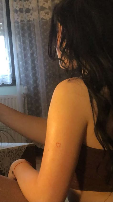 Heart Tattoo Kylie Jenner, Kylie Jenner Tattoo Heart, Kylie Jenner Red Heart Tattoo, Kylie Heart Tattoo, Heart But Tattoo, Back Of Arm Heart Tattoo, Heart Tattoo On Arm For Women, Small Dainty Shoulder Tattoos, Heart On Arm Tattoo