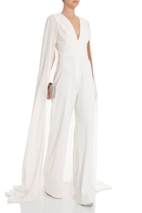 Elie Saab Bklss Jumpsuit W Train  - Deep v neckline and banded waistband  - Cut out back with sheer cape design  - Concealed side zip fastening  Styled with: Alaia shoes, Kotur clutch White Jumpsuit With Cape, Wedding Pantsuit With Cape, Cape Pantsuit, Pantsuit With Cape, Wedding Jumpsuit With Cape, Bridal Pantsuit Brides, Bridal Jumpsuit With Cape, Bridal Jumpsuit With Train, Jumpsuit Bride