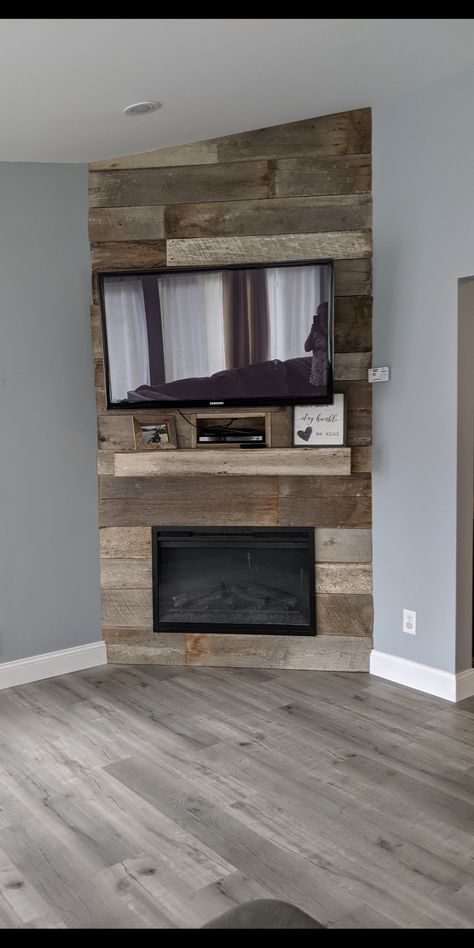 Beautiful way to dress up an electric fireplace! We created this corner fireplace for about $600 including the fireplace and barn wood. It is definitely the focal point of the room and we no longer need the eye sore that was our entertainment center. Entertainment Center Ideas Corner, Faux Corner Fireplace With Tv, Corner Tv Entertainment Center Ideas, Electric Fireplace Ideas With Tv Corner, Built In Corner Entertainment Center, Diy Corner Fireplace Tv Wall, Corner Media Wall With Fire, Corner Entertainment Center Diy, Corner Built In Fireplace And Tv Diy