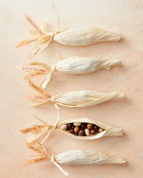 corn husks containing chocolate-covered espresso beans Thanksgiving Place Settings, Corn Husk Crafts, Chocolate Covered Espresso Beans, Corn Husks, Corn Husk Dolls, Thanksgiving Favors, Convention Gifts, Candy Wedding Favors, Treat Holders