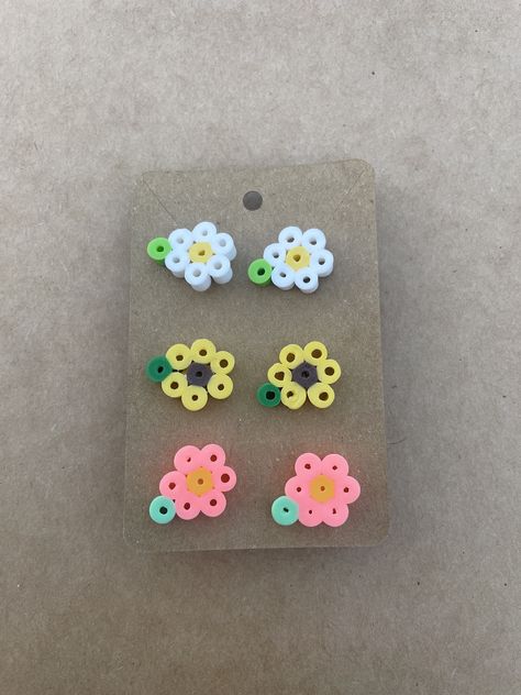 Handmade Perler melting beads, nickel free earring studs. 3 pack: white, yellow and coral pink. Tiny Hama Bead Designs, Kawaii Fuse Beads, Pearl Or Bead Designs, Easy Perler Bead Patterns Minis, Melted Beads Ideas, Pearl Or Beads Ideas, Small Perler Bead Patterns Minis, Perler Beads Flower, Perler Bead Patterns Small Easy Cute