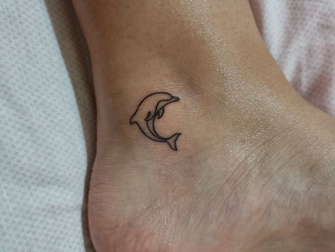 Ankle, Fine line Ankle Dolphin Tattoo, Ocean Tattoos Dolphin, Dolphin Tattoo On Ankle, Holiday Small Tattoos, Dolphin Leg Tattoo, Dolphin Tattoo Behind Ear, 3 Dolphin Tattoo, Small Tattoos Dolphin, Dolphin And Sea Turtle Tattoo