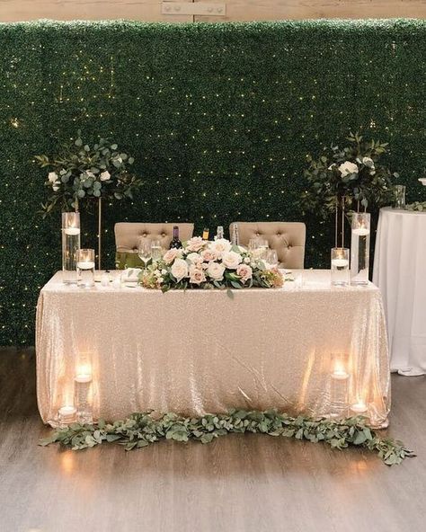 A greenery wall with lights and some greenery decor of the tables and stands look cool and fresh / Modern Neutrals Brides Table, Bride Groom Table, Groom Table, Sweetheart Table Decor, Head Table Decor, Reception Backdrop, Head Table Wedding, Wedding Reception Backdrop, Sweetheart Table Wedding