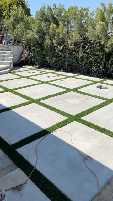 Square Grass Backyard, Concrete Blocks With Turf, Grass And Concrete Backyard, Cement Pavers With Grass In Between, Paver Turf Patio, Drive Way Paving, Cement Squares With Grass In Between, Cement Backyard Ideas, Outside Flooring Ideas