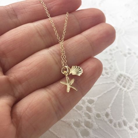 Keep The Seashore With You In This Seashell And Starfish Adorned Dainty Gold Necklace. Made With All 14k Gold Filled Materials, This Necklace Is Water-Resistant, Tarnish-Resistant, And Hypoallergenic. Seashell Measures 7mm While The Starfish Measures 9mm. Chain Measures 1.2 Mm In Width. Choose Your Length At Checkout! Please Note I Have 2 Different Types Of Chains, With Extension On End Or Without. Please Tell Me Which One You Want Or I Will Send Without In The Length You Choose At Checkout. Types Of Chains, Sea Shell Necklace, Canada Trip, Dainty Gold Necklace, Seashell Necklace, Jewelry Lookbook, Shell Necklace, Shell Necklaces, Pretty Jewellery