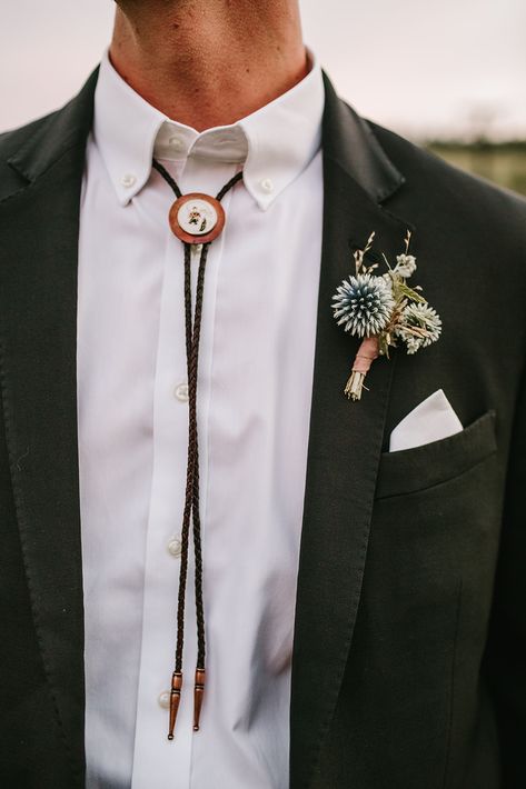 Wedding Suit Bolo Tie, Western Groom Attire Bolo Tie, Tie Alternative Men, Small Wedding Groom Attire, Black Suit With Bolo Tie, Green Suit Bolo Tie, Bolo Tie Groom Attire, Bolo Tie Tuxedo, Black Flower Boutonniere