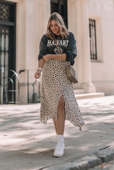 Graphic sweatshirt, midi skirt and sneakers | casual fall outfit styled by Danielle Gervino Midi Skirt With Sweatshirt, White Sneakers With Skirt, Crew Neck And Skirt Outfit, Long Skirt And Trainers Outfit, Trendy Midi Skirt Outfits, Sweatshirt And Midi Skirt Outfit, Sneakers Midi Skirt Outfit, Sweatshirt And Maxi Skirt Outfit, Maxi Skirt Sweatshirt Outfit