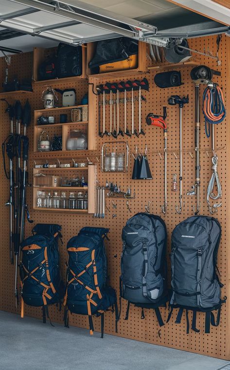 A garage with a pegboard backpacking gear wall displaying organized outdoor gear and backpacks. Outdoor Gear Storage Garage, Hiking Gear Storage Wall, Storage For Outdoor Gear, Garage Outdoor Gear Storage, Hiking Gear Wall, Camping Gear Storage Garage, Ebay Storage Ideas, Hiking Gear Storage Ideas, Organize Camping Gear