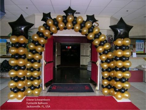 These balloon columns and arch will make a grand entrance piece.   These balloons are not my work, but you can call It's Party Time at 618-651-1505 in Highland, IL if interested in balloon decor like this picture. Grammy Decorations, Prom Balloon Arch, Award Ceremony Decorations, Black And Gold Balloon Arch, Uk Graduation, Prom Balloons, Balloon Archway, Gold Balloon Arch, Broadway Theme