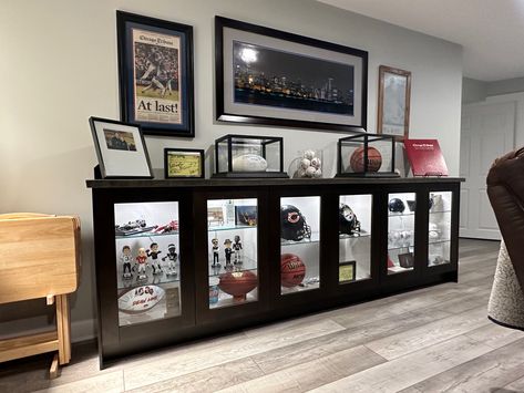 Sports Memorabilia Display Wall Man Cave, Sports Memorabilia Display Wall Shelves, Man Cave Memorabilia Display, Trophy Wall Display Ideas Office, Diy Display Case Ideas, Sports Display Wall, Sports Memorabilia Office, Sports Collectibles Display, Displaying Sports Memorabilia