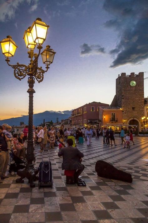 Taormina is a hilltop town on the east coast of Sicily. It sits near Mount Etna, an active volcano with trails leading to the summit. The town is known for the Teatro Antico di Taormina, an ancient Greco-­Roman theater still used today. Near the theater, cliffs drop to the sea forming coves with sandy beaches. A narrow stretch of sand connects to Isola Bella, a tiny island and nature reserve. Italian Trip, Italy Destinations, Sicily Travel, Taormina Sicily, Best Of Italy, Living In Italy, Italy Tours, Italy Aesthetic, Sicily Italy