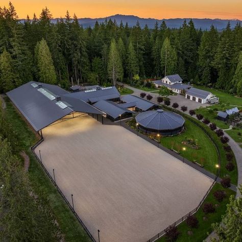 HorseProperties.Net® on Instagram: "LOST LAKE FARM - A CAPTIVATING MASTERPIECE ON 23 ACRES | Snohomish, Washington Lost Lake Farm, destined to be a NW Landmark in Equestrian living. A captivating masterpiece built in 2019 sited on over 23 perfected acres. Unparalleled State of the art horse facilities, 19 stalls, 80 x 200 covered arena blends seamlessly into a 110 X 200 outdoor portion for a total of 400' length. Hoofgrid paddocks, heated viewing rm, steel board fencing and countless equine amenities. Over 5000 SF Modern Farmhouse offers grand Great Room design w/ massive pocket doors opening to a forested backdrop & outdoor living spaces. The home and its surroundings were thoughtfully designed and executed with a no expense spared approach from start to finish. 2 gated entries, updated 2 Equestrian Center Design, Paddocks For Horses, Outdoor Horse Stalls, Horse Arena Fencing, Horse Paddock Ideas, Outdoor Horse Arena, Home Stables, Horse Stable Ideas, Barn Designs Ideas